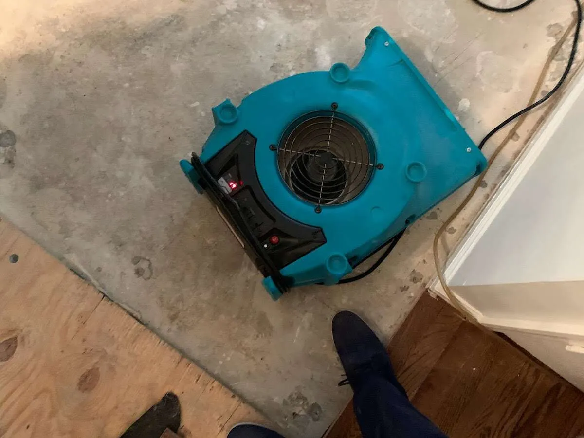 Air mover drying subfloor during Commercial Water Damage Restoration in Palmyra